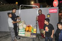 Staff of Hotel Granada assist in loading the necessities into the chartered bus